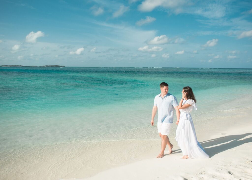 Bride and groom walking on a beach 