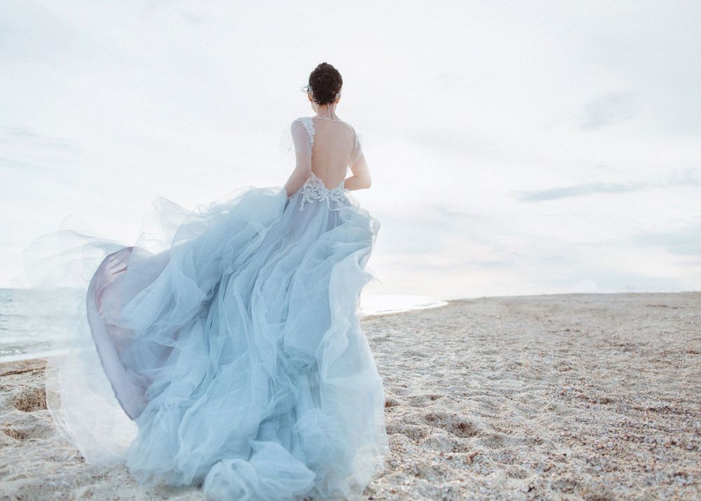 Bride running on a beach at a destination wedding 