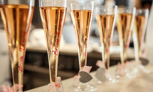 Flutes of champaign with bridesmaids written on the side 