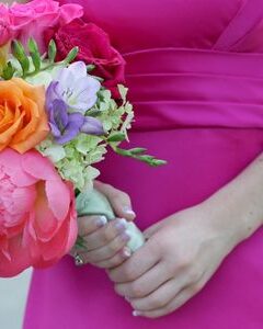 Bridesmaid in hot pin dress in stunning destination wedding color combination