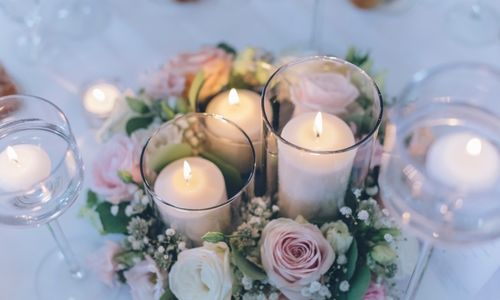 Wedding head table setting with candles and flower arrangement