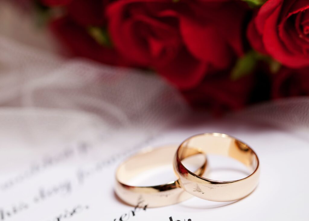 Wedding bands and wedding vows with flowers