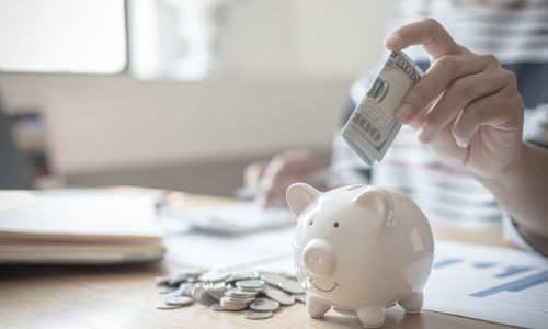 Adding bills to honeymoon fund piggy bank