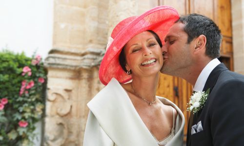 mother of the groom with red hat