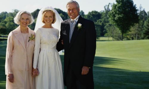 mother and father of the bride with their daughter